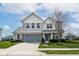 Charming two-story home boasts a well-kept lawn, stylish siding, and an attached two-car garage at 16753 Workington Way, Westfield, IN 46074