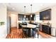 Stylish kitchen with dark cabinetry, granite countertops, stainless steel appliances, and center island at 16753 Workington Way, Westfield, IN 46074