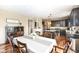 Open-concept kitchen with dark cabinetry, granite countertops, and stainless steel appliances at 16753 Workington Way, Westfield, IN 46074
