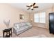 Inviting living room with neutral walls, plush carpet, ceiling fan and comfortable seating arrangement at 16753 Workington Way, Westfield, IN 46074