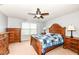 Bedroom with traditional wood furniture, fan, and a blue and white quilt at 16753 Workington Way, Westfield, IN 46074