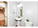 Clean powder room with pedestal sink and modern fixtures, next to a staircase at 16753 Workington Way, Westfield, IN 46074