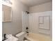Bright bathroom featuring a shower-tub combo and clean, tiled walls at 1707 N Leland Ave, Indianapolis, IN 46218