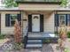 Inviting front door with decorative glass and cozy covered porch featuring black accents and charming curb appeal at 1707 N Leland Ave, Indianapolis, IN 46218