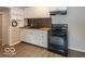 Bright kitchen featuring white cabinetry, modern appliances, and an eye-catching backsplash at 1707 N Leland Ave, Indianapolis, IN 46218
