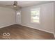 Inviting living room with wood floors, ceiling fan, ample natural light, and neutral walls at 1707 N Leland Ave, Indianapolis, IN 46218
