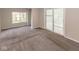 A carpeted living room with sliding glass doors providing natural light at 1707 N Leland Ave, Indianapolis, IN 46218
