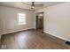 Bright, open living area with wood floors, neutral walls, ceiling fan, and stainless steel refrigerator in view at 1707 N Leland Ave, Indianapolis, IN 46218