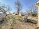 Spacious backyard featuring a wooden deck, lush green grass, and mature trees, ideal for outdoor activities at 1830 N Livingston Ave, Indianapolis, IN 46222