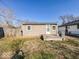 View of the backyard area featuring partial grass, utility storage, and the back of the home at 1830 N Livingston Ave, Indianapolis, IN 46222