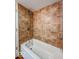 Bathroom tub and shower has brown tile surround at 1830 N Livingston Ave, Indianapolis, IN 46222