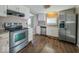 Stainless steel appliances, granite countertops and wood-look flooring in this kitchen at 1830 N Livingston Ave, Indianapolis, IN 46222