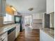 Well-lit kitchen with modern appliances and granite countertops overlooking an adjacent hallway at 1830 N Livingston Ave, Indianapolis, IN 46222