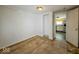 Open room with a door that leads to a bright kitchen at 1830 N Livingston Ave, Indianapolis, IN 46222