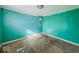 Empty room featuring aqua walls and worn flooring, offering a blank canvas for customization at 1830 N Livingston Ave, Indianapolis, IN 46222