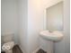 Powder room featuring a pedestal sink, a large mirror, and neutral decor at 2290 Oakmont Dr, Plainfield, IN 46168