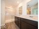Modern bathroom with double vanity, dark cabinets, and a glass-enclosed shower with marble-style walls at 2290 Oakmont Dr, Plainfield, IN 46168