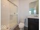 Clean bathroom showcasing a white shower with glass door, toilet, and vanity with mirror at 2290 Oakmont Dr, Plainfield, IN 46168