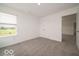 A bright bedroom features a window, neutral carpet, and a double-door closet at 2290 Oakmont Dr, Plainfield, IN 46168