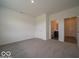 Spacious bedroom featuring neutral carpet, white walls, and access to an ensuite bathroom at 2290 Oakmont Dr, Plainfield, IN 46168