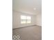 Bright bedroom features a large window overlooking a scenic view, and neutral carpeting at 2290 Oakmont Dr, Plainfield, IN 46168