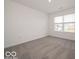 This bedroom has neutral walls and carpet and a view from the window at 2290 Oakmont Dr, Plainfield, IN 46168