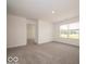 Sun-filled bedroom with large window offering a scenic view; neutral walls and carpet create a calming atmosphere at 2290 Oakmont Dr, Plainfield, IN 46168