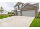 Attractive two-story home featuring brick accents, a wide driveway, and a well-kept lawn at 2290 Oakmont Dr, Plainfield, IN 46168