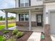 Inviting front porch with sturdy columns, brick accents, and charming landscaping at 2290 Oakmont Dr, Plainfield, IN 46168