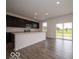 Modern kitchen with stainless steel appliances, dark cabinets, and white countertops at 2290 Oakmont Dr, Plainfield, IN 46168