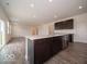 Kitchen island with seating, stainless steel dishwasher and view of the sliding door at 2290 Oakmont Dr, Plainfield, IN 46168