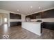 Open kitchen features a central island, stainless steel appliances, and ample cabinet space at 2290 Oakmont Dr, Plainfield, IN 46168