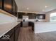 Stylish kitchen with stainless steel appliances, dark cabinets, and a large central island at 2290 Oakmont Dr, Plainfield, IN 46168