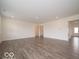 Spacious living room boasts laminate flooring and neutral color palette at 2290 Oakmont Dr, Plainfield, IN 46168