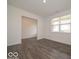 Spacious living room featuring wood-look floors, natural light, and an open layout at 2290 Oakmont Dr, Plainfield, IN 46168