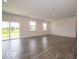 Bright, open-plan living area featuring wood-look floors, sliding glass doors, and ample natural light at 2290 Oakmont Dr, Plainfield, IN 46168