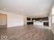 Bright, open-concept living area flows into kitchen with modern finishes and laminate flooring at 2290 Oakmont Dr, Plainfield, IN 46168