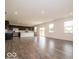 Open-concept living space with wood-look floors, stainless steel appliances, and sliding glass doors at 2290 Oakmont Dr, Plainfield, IN 46168