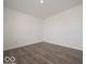 Cozy room featuring wood-look floors, ample space, and a neutral color palette at 2290 Oakmont Dr, Plainfield, IN 46168