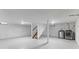 Spacious basement featuring washer and dryer hookups, painted floors, stairs, and bright lighting at 2315 Caldwell Pl, Columbus, IN 47201