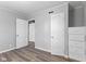 Bedroom with gray walls, wood-look floors, and a built-in closet/dresser at 2315 Caldwell Pl, Columbus, IN 47201
