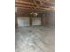 Spacious two-car garage interior with wood beams, unfinished walls, concrete floor, and garage doors at 2315 Caldwell Pl, Columbus, IN 47201