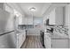 Kitchen featuring white cabinets, stainless steel appliances, and modern backsplash at 2315 Caldwell Pl, Columbus, IN 47201