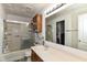 Standard bathroom with a tub and sliding shower doors, sink, and mirror at 2992 Sentiment Ln, Greenwood, IN 46143