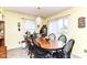 Cozy dining area features black chairs, wooden table, chandelier, and sliding glass door at 2992 Sentiment Ln, Greenwood, IN 46143