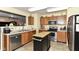 Galley style kitchen featuring wooden cabinets, stainless steel appliances, and center island at 2992 Sentiment Ln, Greenwood, IN 46143