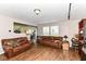 Inviting living room with hardwood floors and two leather couches at 2992 Sentiment Ln, Greenwood, IN 46143