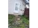 Overgrown backyard with a door that reads 'Stay Out' offering redevelopment opportunities at 335 S Dearborn St, Indianapolis, IN 46201