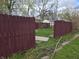 The backyard is enclosed by a maroon wooden fence with an opening at 335 S Dearborn St, Indianapolis, IN 46201