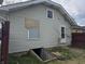 Back exterior of home with walkout basement access and boarded up window at 335 S Dearborn St, Indianapolis, IN 46201